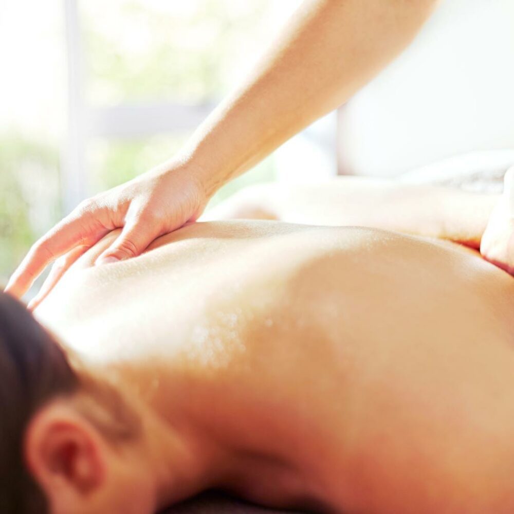 Photo of person lying face down on a massage table getting a myofascial release massage.